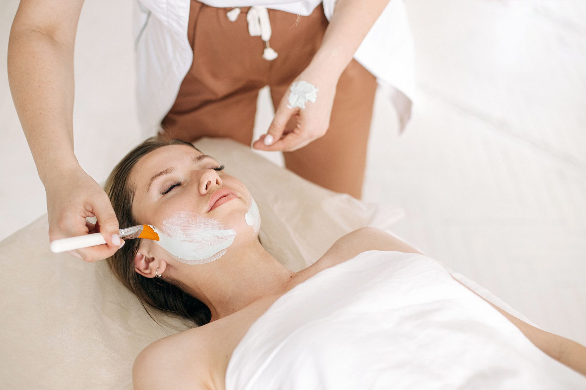 A practitioner applying a treatment mask to a patient's face