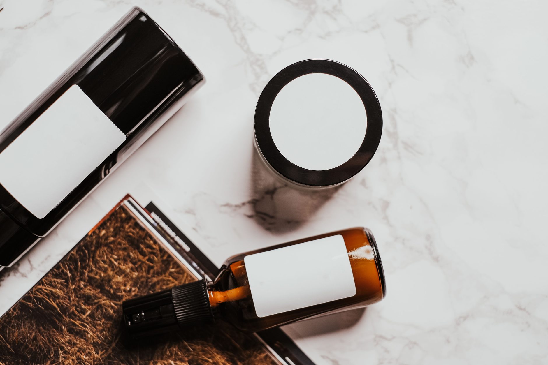 Skincare products arranged on a pale marble surface