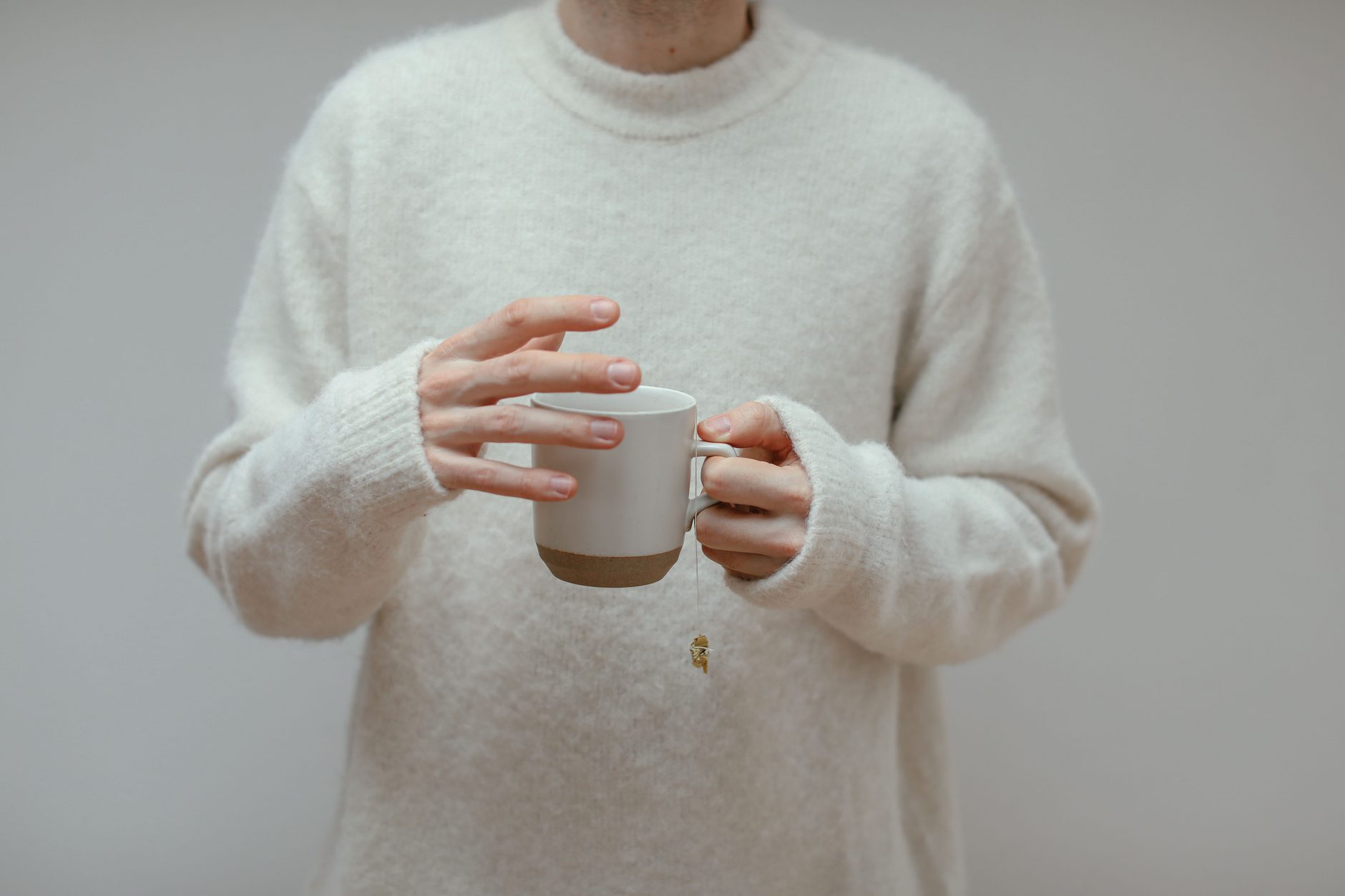 A person holding a warm cup in both hands