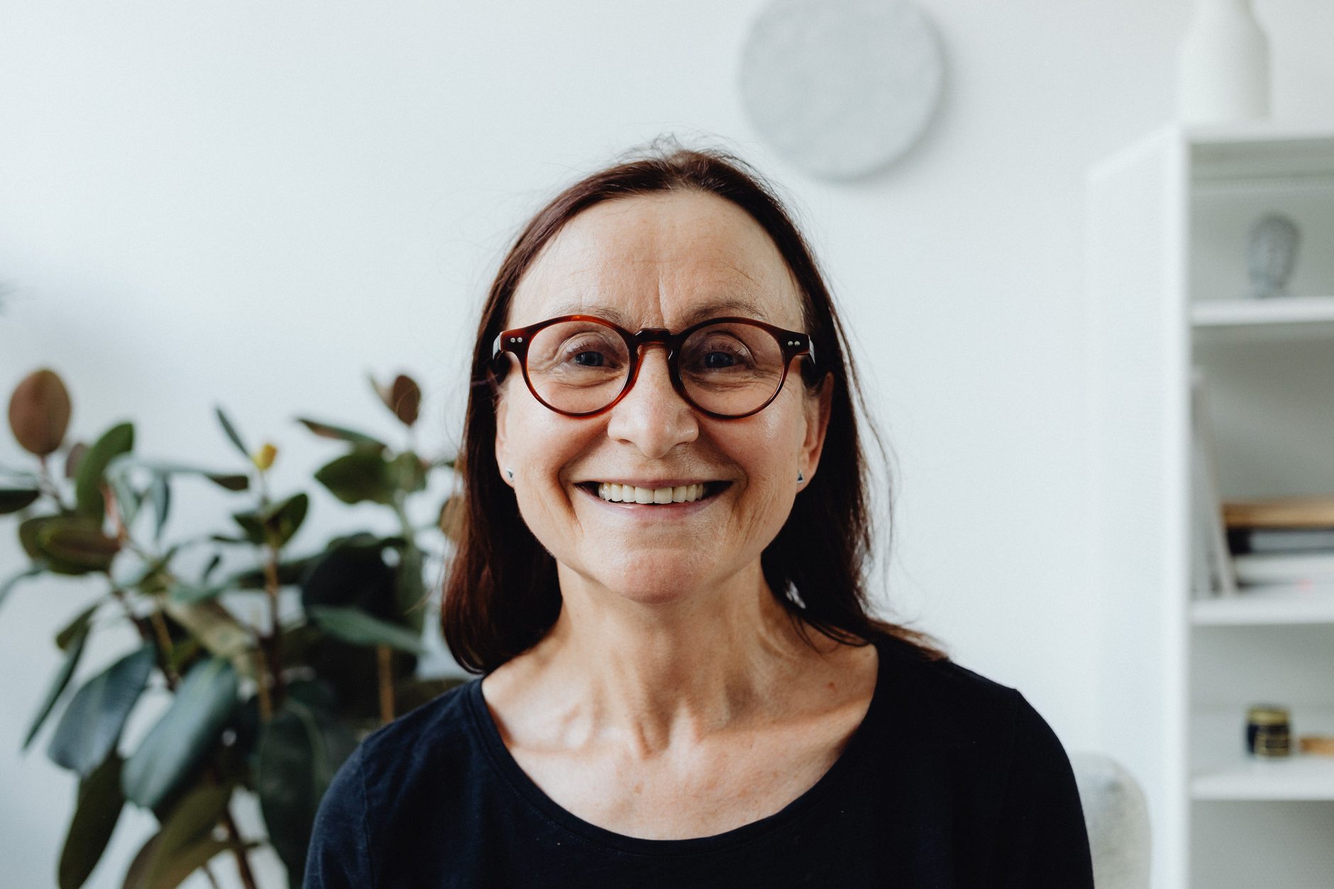 A smiling woman in a bright room